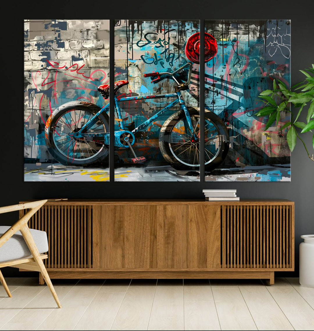 A modern living room features a triptych wall art of an abstract bicycle, designed in a graffiti style on a brick wall. This piece is expertly crafted on the Abstract Bicycle Wall Art Canvas Print, offering a premium canvas that ensures a gallery-quality finish.