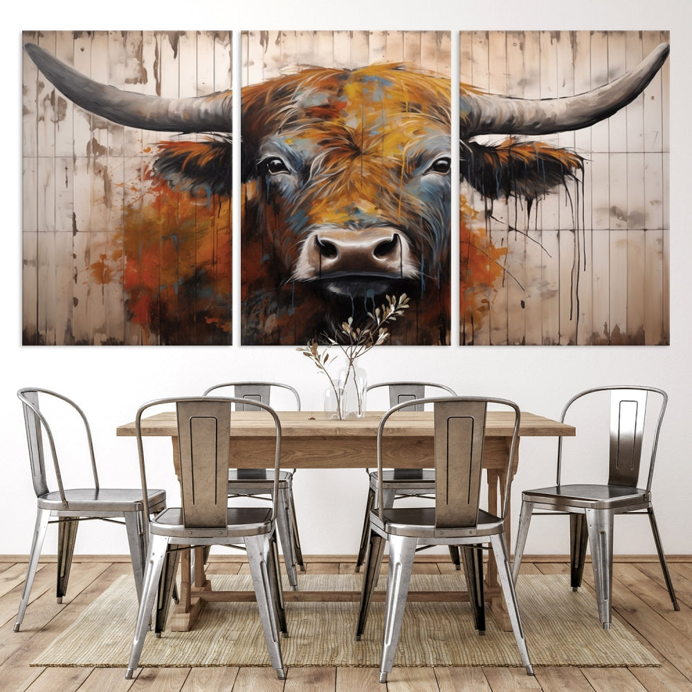 The "Abstract Bull Highland Cow Canvas Wall Art Print," displayed as a three-panel piece, adds vibrant rustic charm to a living room. Its depiction of a large, horned bull beautifully complements the elegance of modern farmhouse decor.