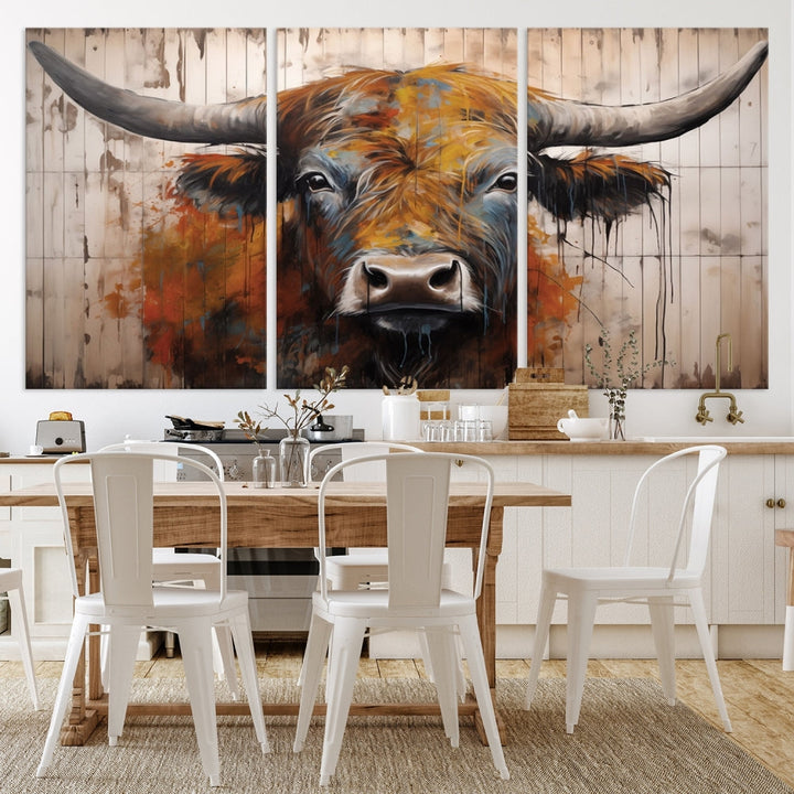 The "Abstract Bull Highland Cow Canvas Wall Art Print," displayed as a three-panel piece, adds vibrant rustic charm to a living room. Its depiction of a large, horned bull beautifully complements the elegance of modern farmhouse decor.