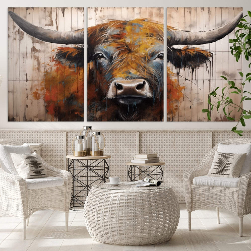 The "Abstract Bull Highland Cow Canvas Wall Art Print," displayed as a three-panel piece, adds vibrant rustic charm to a living room. Its depiction of a large, horned bull beautifully complements the elegance of modern farmhouse decor.