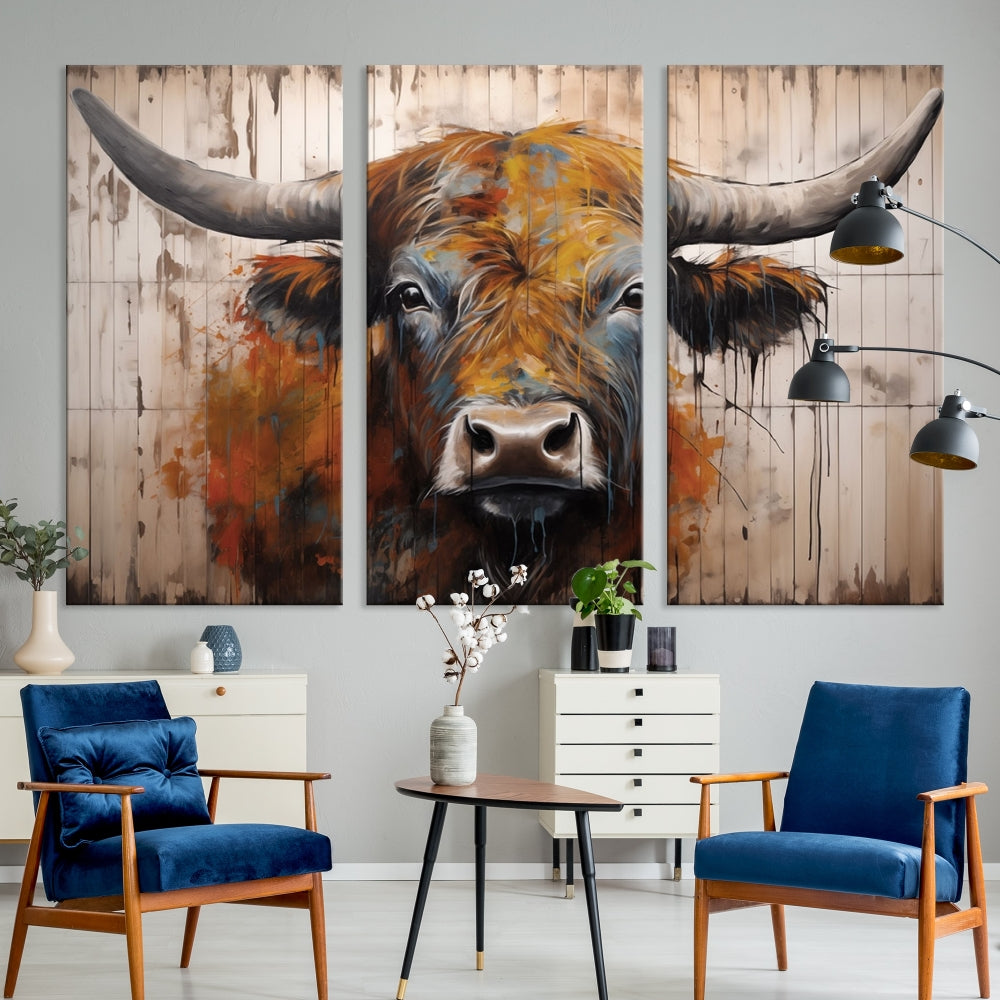 The "Abstract Bull Highland Cow Canvas Wall Art Print," displayed as a three-panel piece, adds vibrant rustic charm to a living room. Its depiction of a large, horned bull beautifully complements the elegance of modern farmhouse decor.