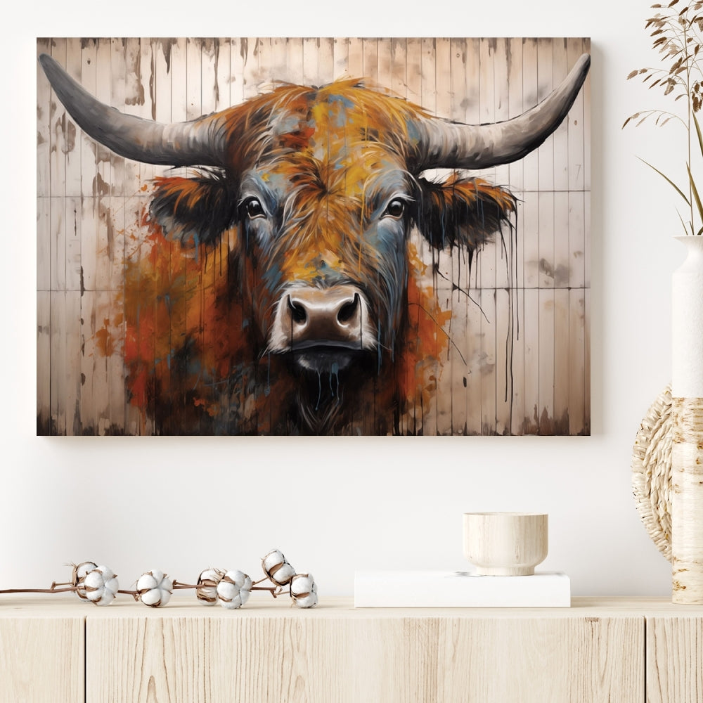 The "Abstract Bull Highland Cow Canvas Wall Art Print," displayed as a three-panel piece, adds vibrant rustic charm to a living room. Its depiction of a large, horned bull beautifully complements the elegance of modern farmhouse decor.