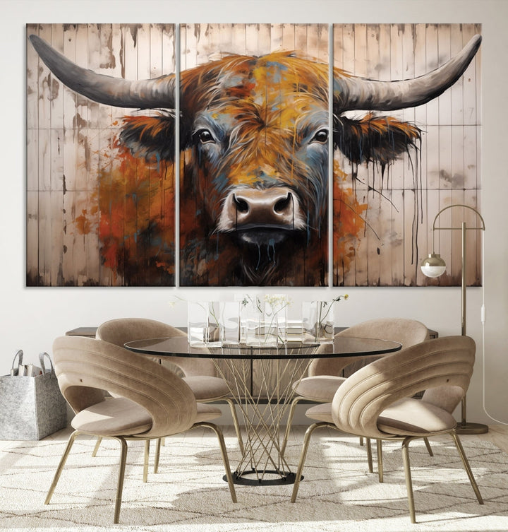 The "Abstract Bull Highland Cow Canvas Wall Art Print," displayed as a three-panel piece, adds vibrant rustic charm to a living room. Its depiction of a large, horned bull beautifully complements the elegance of modern farmhouse decor.