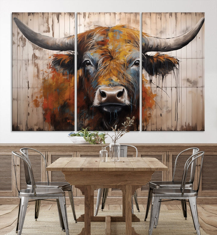 The "Abstract Bull Highland Cow Canvas Wall Art Print," displayed as a three-panel piece, adds vibrant rustic charm to a living room. Its depiction of a large, horned bull beautifully complements the elegance of modern farmhouse decor.