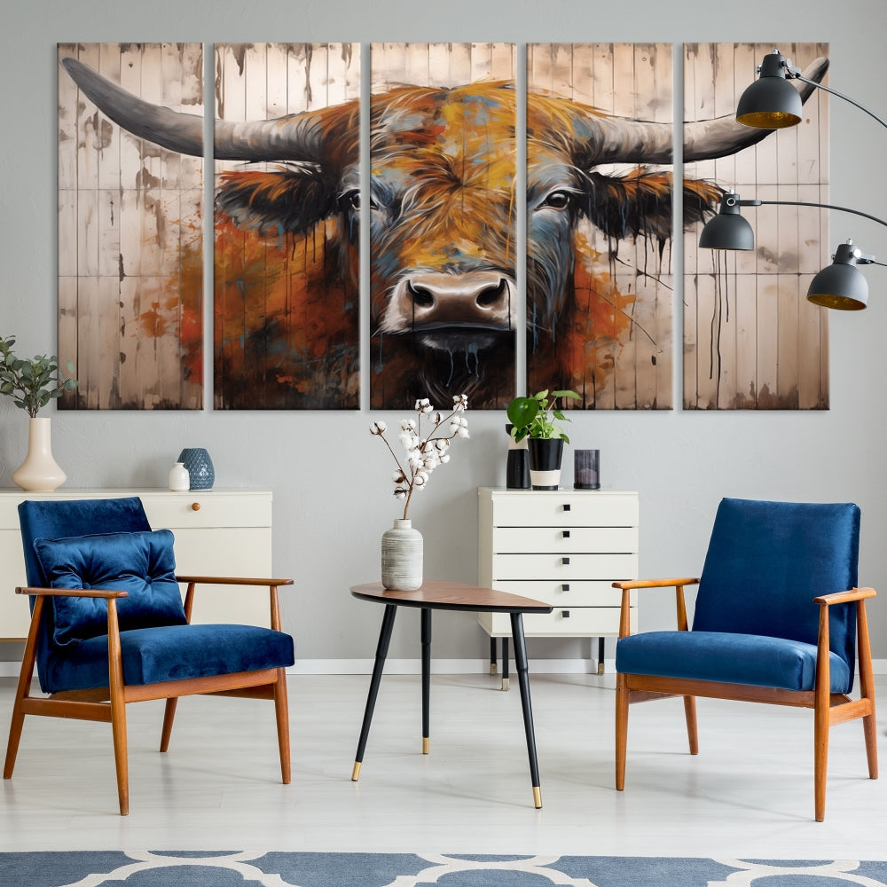 The "Abstract Bull Highland Cow Canvas Wall Art Print," displayed as a three-panel piece, adds vibrant rustic charm to a living room. Its depiction of a large, horned bull beautifully complements the elegance of modern farmhouse decor.