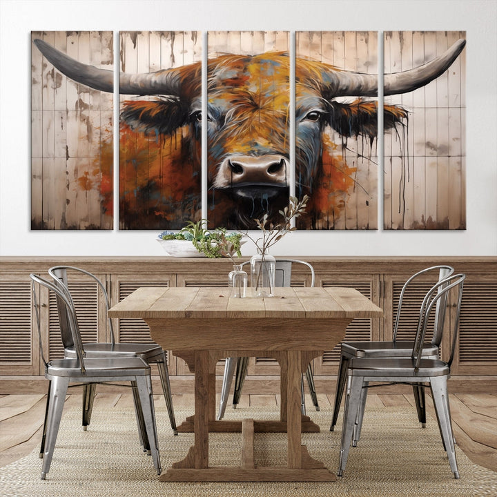 The "Abstract Bull Highland Cow Canvas Wall Art Print," displayed as a three-panel piece, adds vibrant rustic charm to a living room. Its depiction of a large, horned bull beautifully complements the elegance of modern farmhouse decor.