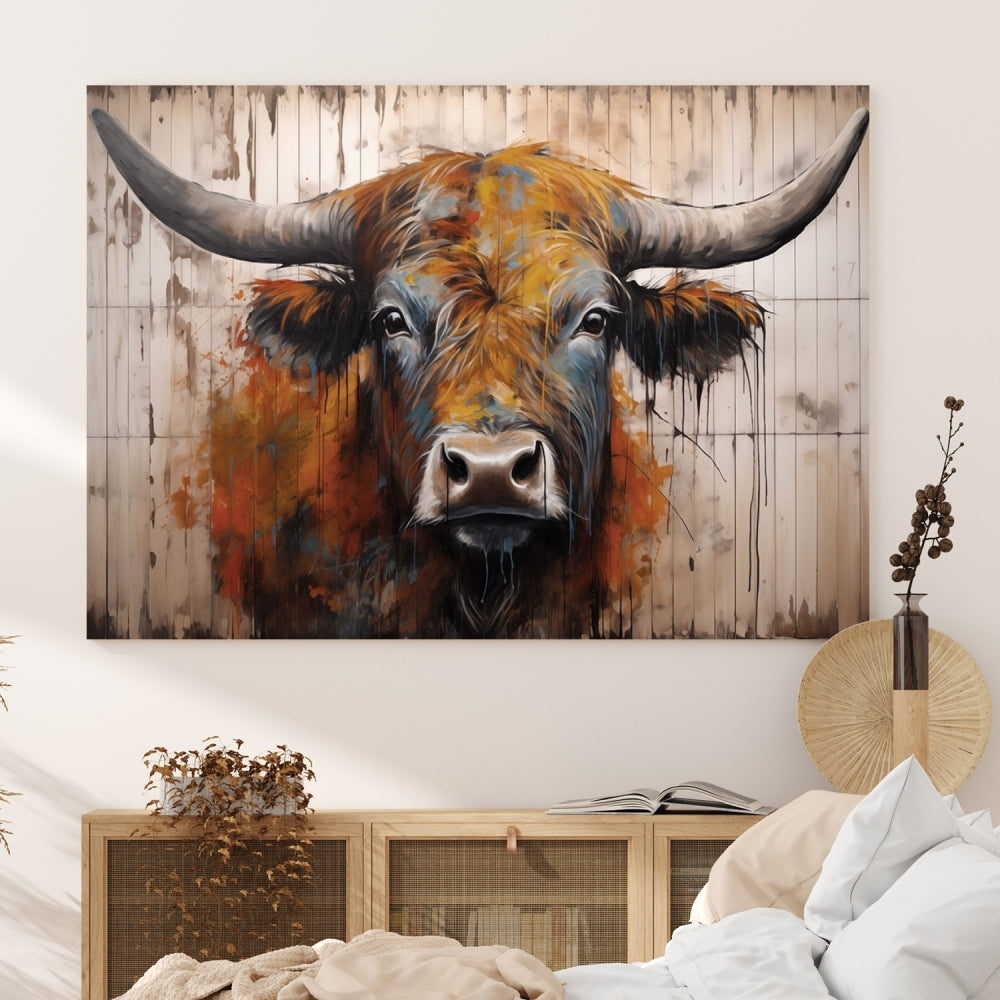 The "Abstract Bull Highland Cow Canvas Wall Art Print," displayed as a three-panel piece, adds vibrant rustic charm to a living room. Its depiction of a large, horned bull beautifully complements the elegance of modern farmhouse decor.