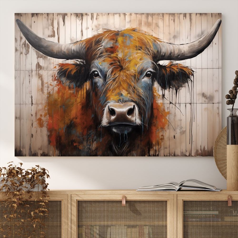 The "Abstract Bull Highland Cow Canvas Wall Art Print," displayed as a three-panel piece, adds vibrant rustic charm to a living room. Its depiction of a large, horned bull beautifully complements the elegance of modern farmhouse decor.