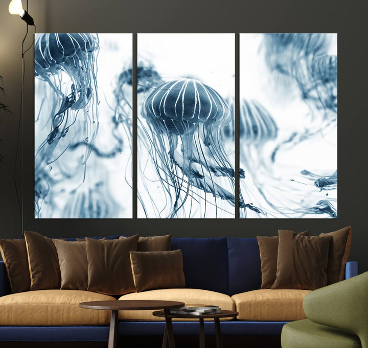 The "Abstract Jellyfish Wall Art Canvas Print" in high resolution is beautifully displayed as a triptych on a dark wall. Experience museum-quality canvas and enjoy free shipping with this stunning piece.