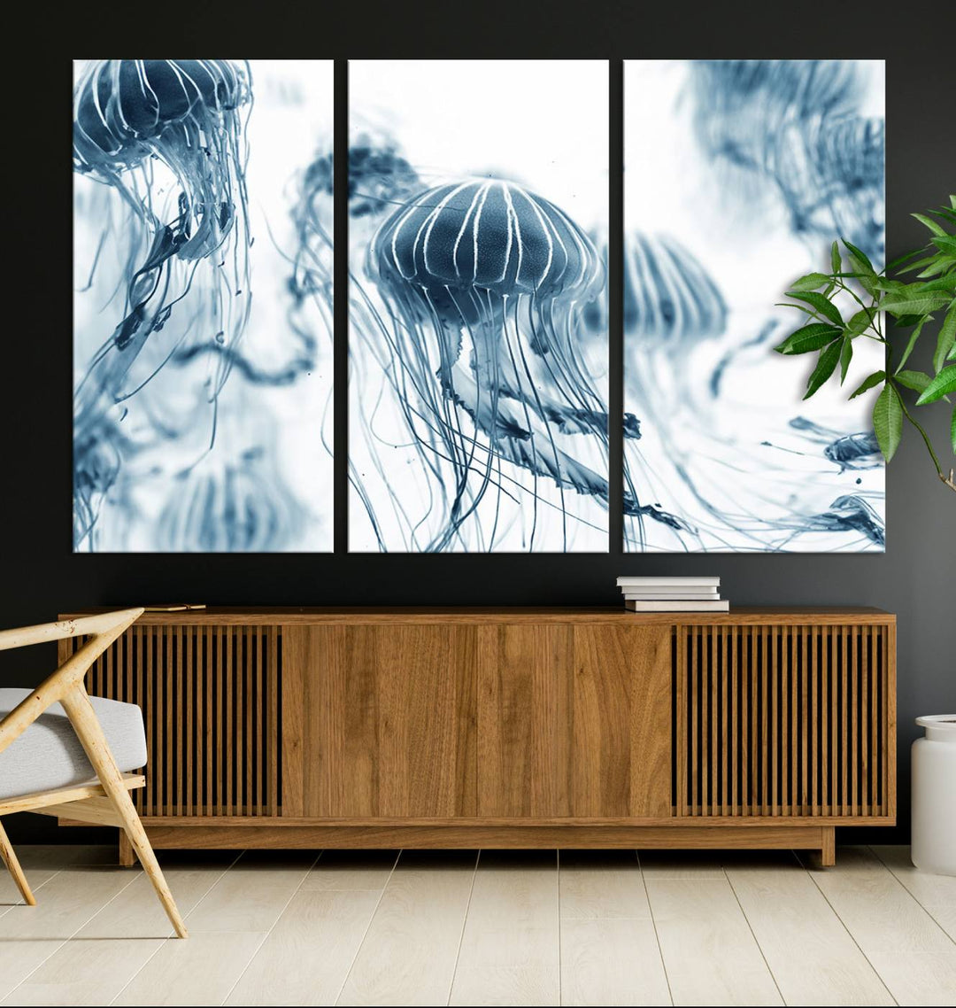 The "Abstract Jellyfish Wall Art Canvas Print" in high resolution is beautifully displayed as a triptych on a dark wall. Experience museum-quality canvas and enjoy free shipping with this stunning piece.