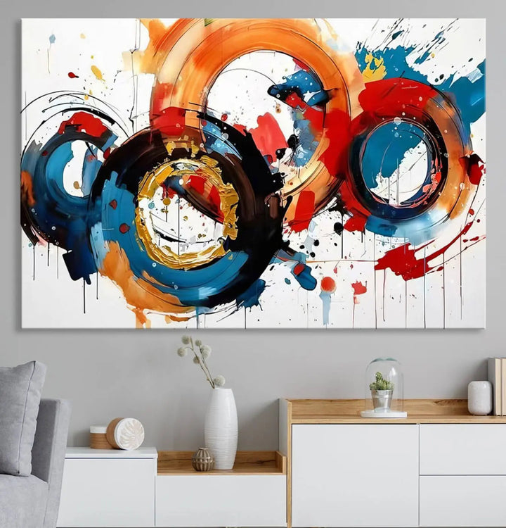 The Abstract Wall Art Rings Canvas Print, with its bold and colorful circular strokes, adorns the wall, epitomizing contemporary design.