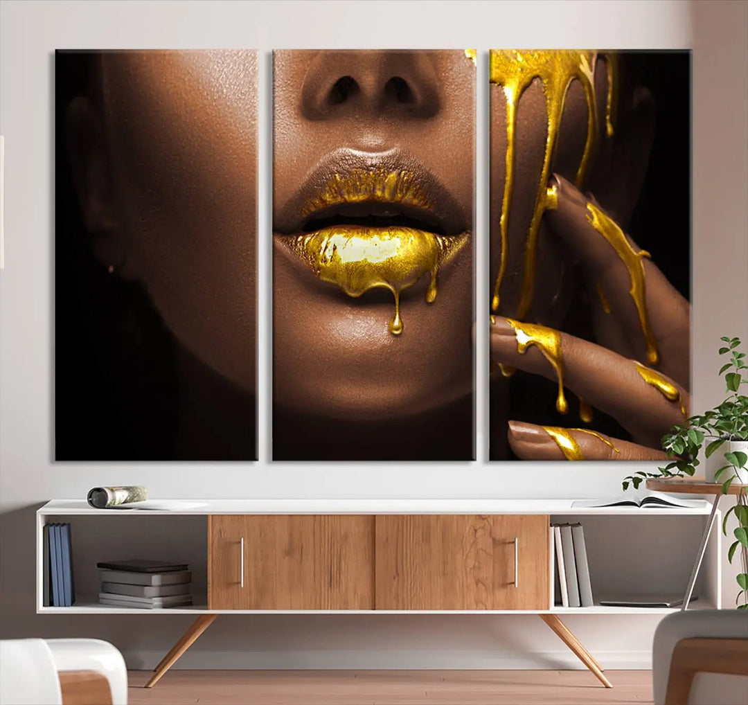 A triptych art display of the African American Art Black Woman Canvas Print, featuring gold-painted lips inspired by fashion and luxury, is elegantly arranged.