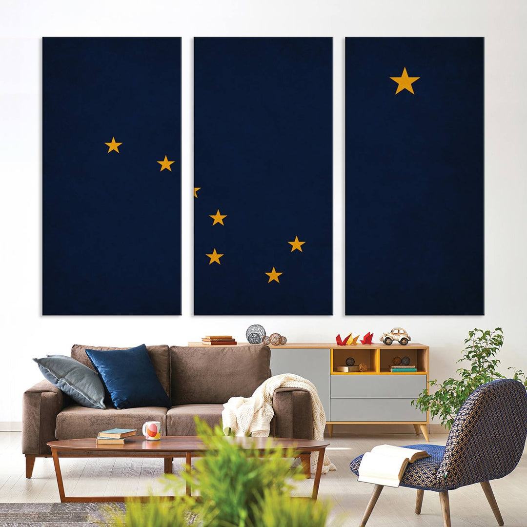 A contemporary living room featuring a triptych artwork of stars on a navy background, accentuated by the striking Alaska States Flag Wall Art Canvas Print.