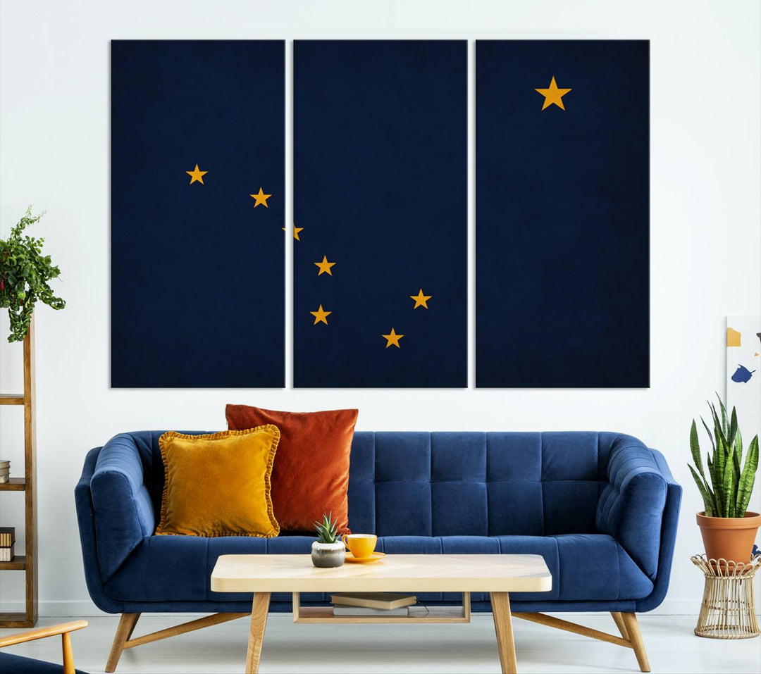 A contemporary living room featuring a triptych artwork of stars on a navy background, accentuated by the striking Alaska States Flag Wall Art Canvas Print.