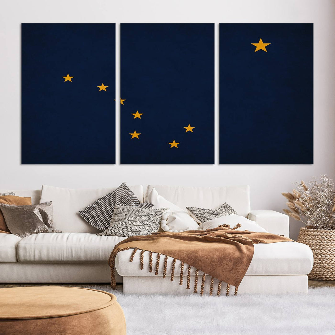 A contemporary living room featuring a triptych artwork of stars on a navy background, accentuated by the striking Alaska States Flag Wall Art Canvas Print.