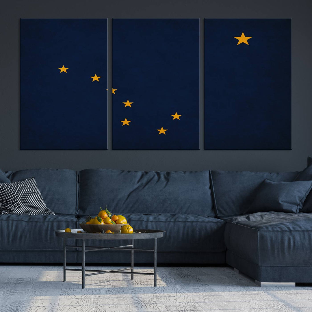 A contemporary living room featuring a triptych artwork of stars on a navy background, accentuated by the striking Alaska States Flag Wall Art Canvas Print.