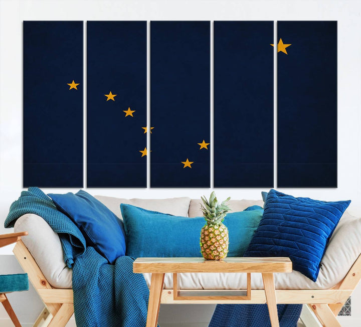 A contemporary living room featuring a triptych artwork of stars on a navy background, accentuated by the striking Alaska States Flag Wall Art Canvas Print.