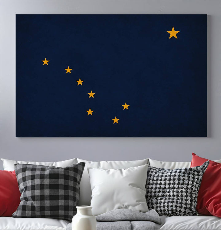 A contemporary living room featuring a triptych artwork of stars on a navy background, accentuated by the striking Alaska States Flag Wall Art Canvas Print.