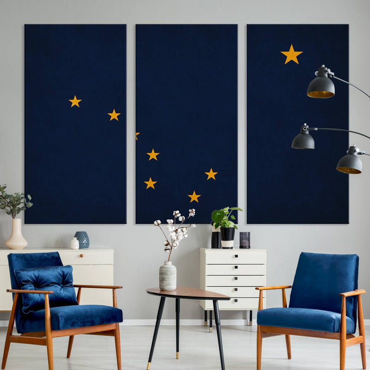 A contemporary living room featuring a triptych artwork of stars on a navy background, accentuated by the striking Alaska States Flag Wall Art Canvas Print.