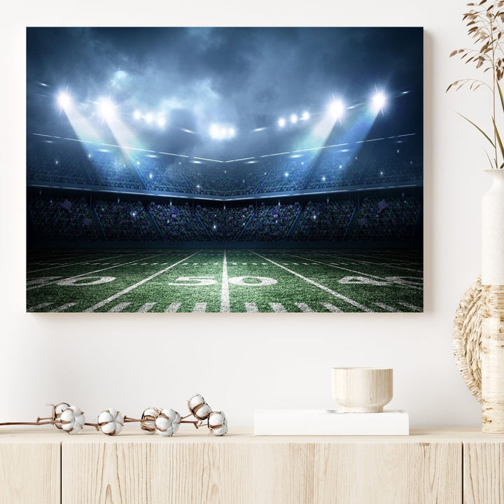 The *American Football Stadium Wall Art Canvas Print*, showcasing a lit football stadium, hangs prominently.