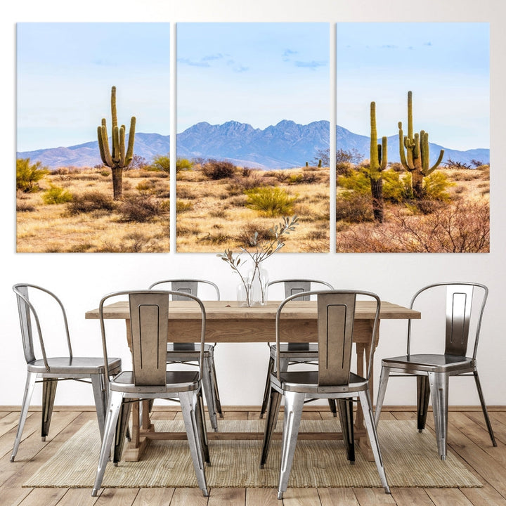 The Arizona Desert Cactus Wall Art Canvas Print, positioned above the console in a modern room, showcases a triptych desert landscape featuring cacti and mountains. Crafted on museum-quality polycotton canvas, it is finished with gallery-wrapped edges and an advanced UV-protective coating.