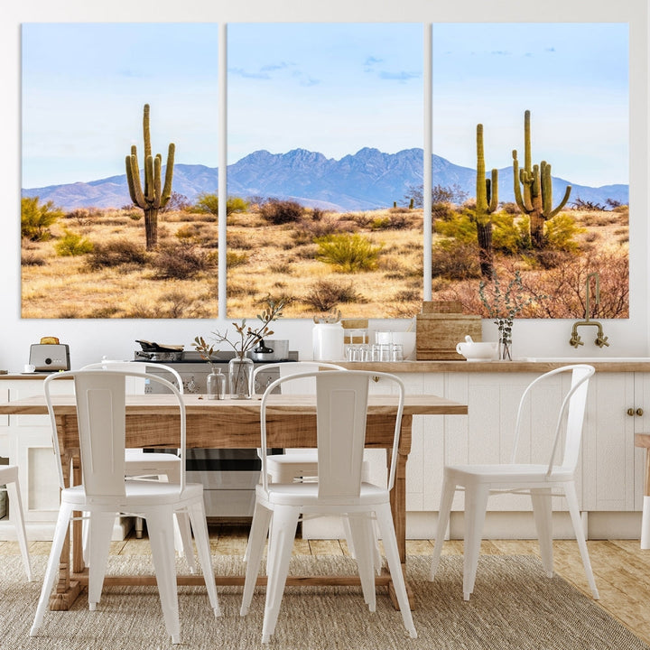 The Arizona Desert Cactus Wall Art Canvas Print, positioned above the console in a modern room, showcases a triptych desert landscape featuring cacti and mountains. Crafted on museum-quality polycotton canvas, it is finished with gallery-wrapped edges and an advanced UV-protective coating.