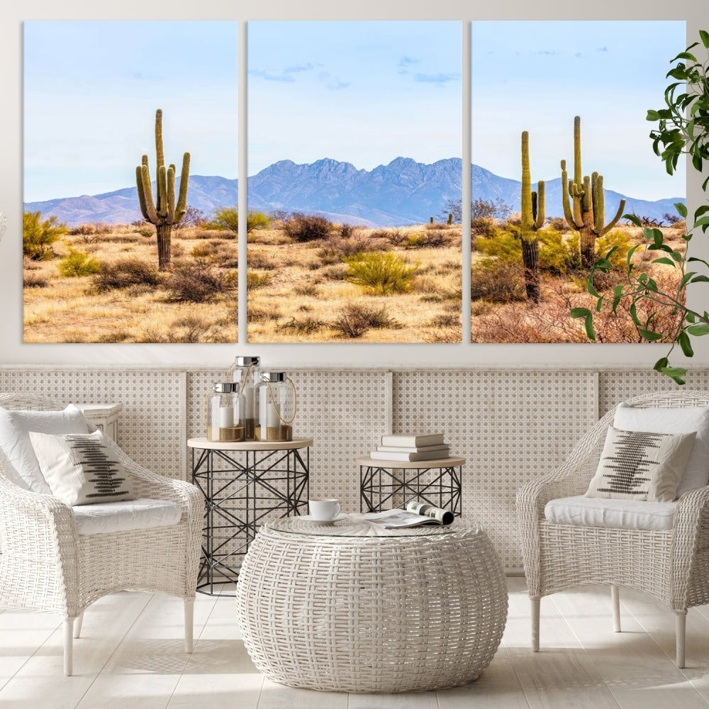 The Arizona Desert Cactus Wall Art Canvas Print, positioned above the console in a modern room, showcases a triptych desert landscape featuring cacti and mountains. Crafted on museum-quality polycotton canvas, it is finished with gallery-wrapped edges and an advanced UV-protective coating.