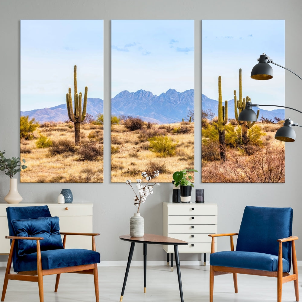 The Arizona Desert Cactus Wall Art Canvas Print, positioned above the console in a modern room, showcases a triptych desert landscape featuring cacti and mountains. Crafted on museum-quality polycotton canvas, it is finished with gallery-wrapped edges and an advanced UV-protective coating.