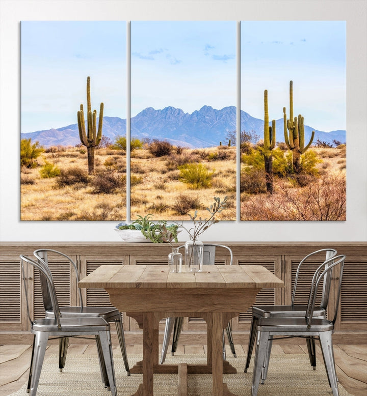 The Arizona Desert Cactus Wall Art Canvas Print, positioned above the console in a modern room, showcases a triptych desert landscape featuring cacti and mountains. Crafted on museum-quality polycotton canvas, it is finished with gallery-wrapped edges and an advanced UV-protective coating.