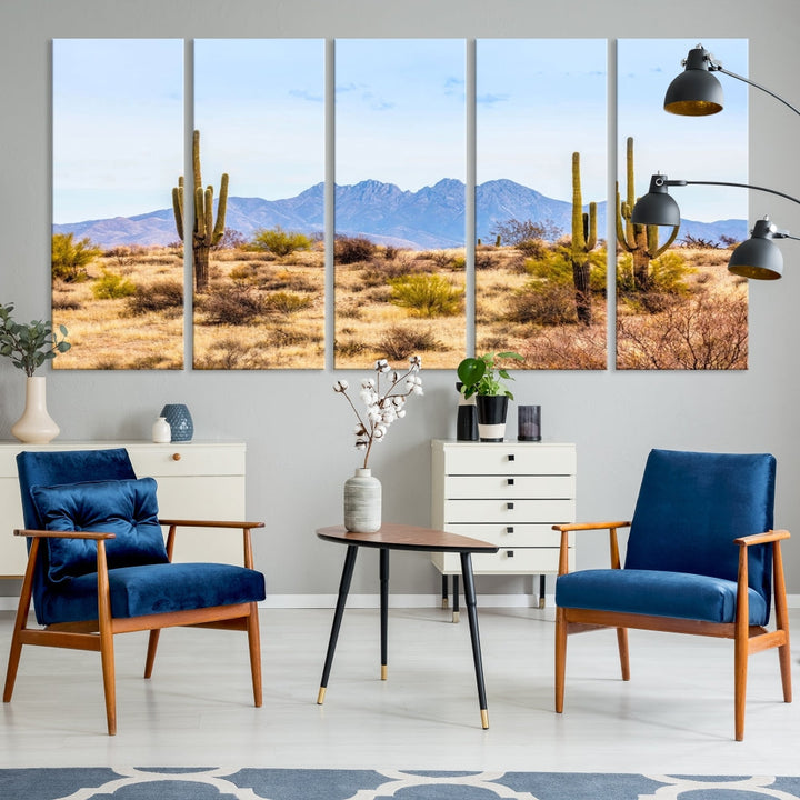 The Arizona Desert Cactus Wall Art Canvas Print, positioned above the console in a modern room, showcases a triptych desert landscape featuring cacti and mountains. Crafted on museum-quality polycotton canvas, it is finished with gallery-wrapped edges and an advanced UV-protective coating.