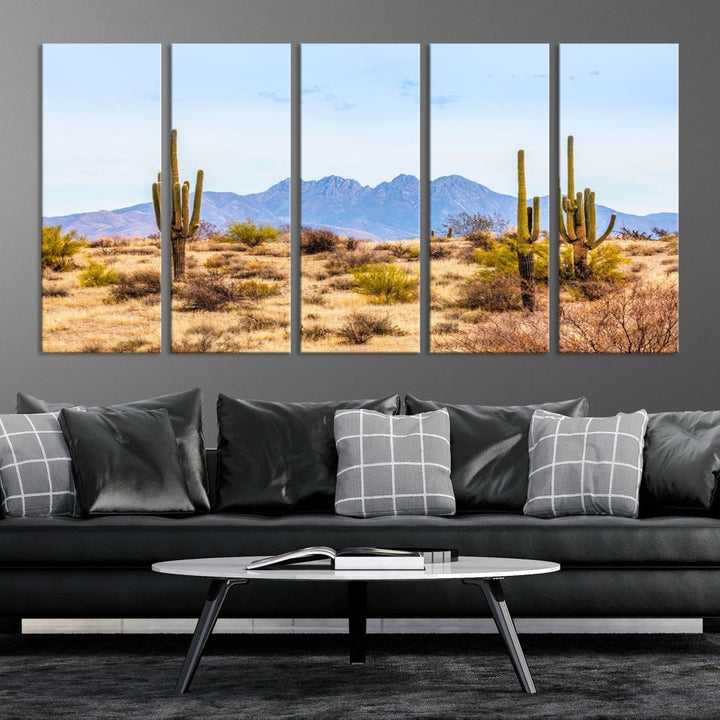 The Arizona Desert Cactus Wall Art Canvas Print, positioned above the console in a modern room, showcases a triptych desert landscape featuring cacti and mountains. Crafted on museum-quality polycotton canvas, it is finished with gallery-wrapped edges and an advanced UV-protective coating.