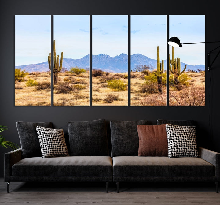 The Arizona Desert Cactus Wall Art Canvas Print, positioned above the console in a modern room, showcases a triptych desert landscape featuring cacti and mountains. Crafted on museum-quality polycotton canvas, it is finished with gallery-wrapped edges and an advanced UV-protective coating.