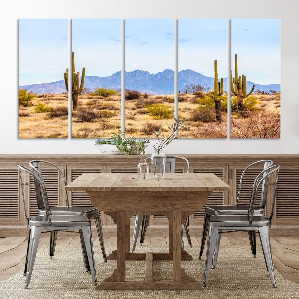 The Arizona Desert Cactus Wall Art Canvas Print, positioned above the console in a modern room, showcases a triptych desert landscape featuring cacti and mountains. Crafted on museum-quality polycotton canvas, it is finished with gallery-wrapped edges and an advanced UV-protective coating.