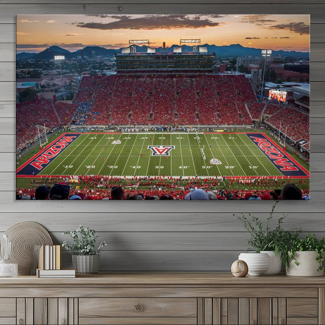 The Arizona Wildcats Football Team Print, a stunning canvas depiction of the Tucson Arizona Stadium at sunset, elegantly hangs in the room.