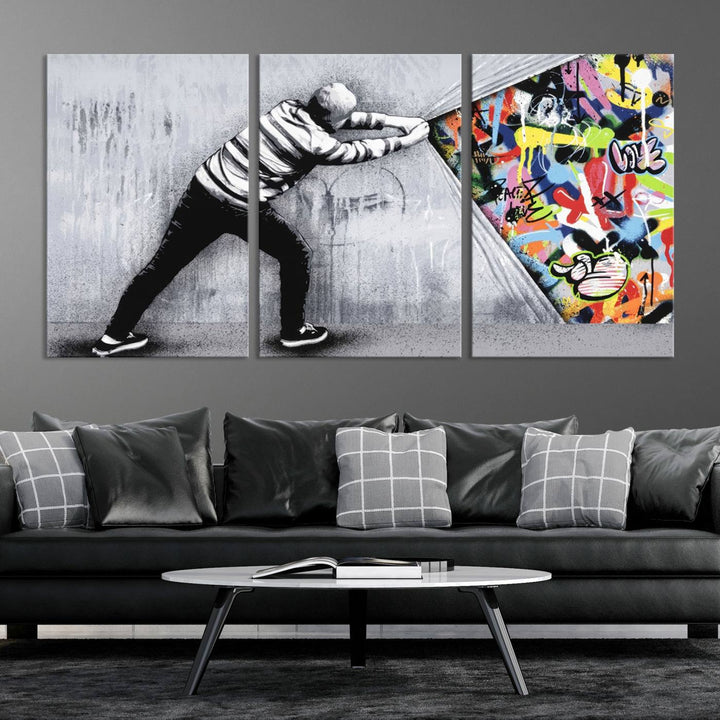 Triptych featuring the Banksy Art Behind the Curtain Street Wall Art Canvas Print, where a person peels away a gray wall to reveal vibrant urban graffiti, reminiscent of dynamic street art.