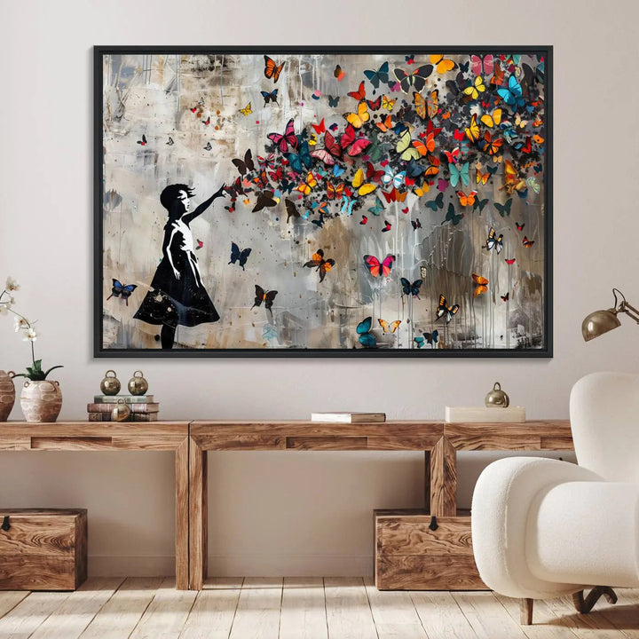 The Banksy Butterfly Girl 3-piece canvas art showcases a silhouette of a girl surrounded by colorful butterflies, perfect for modern living room decor.