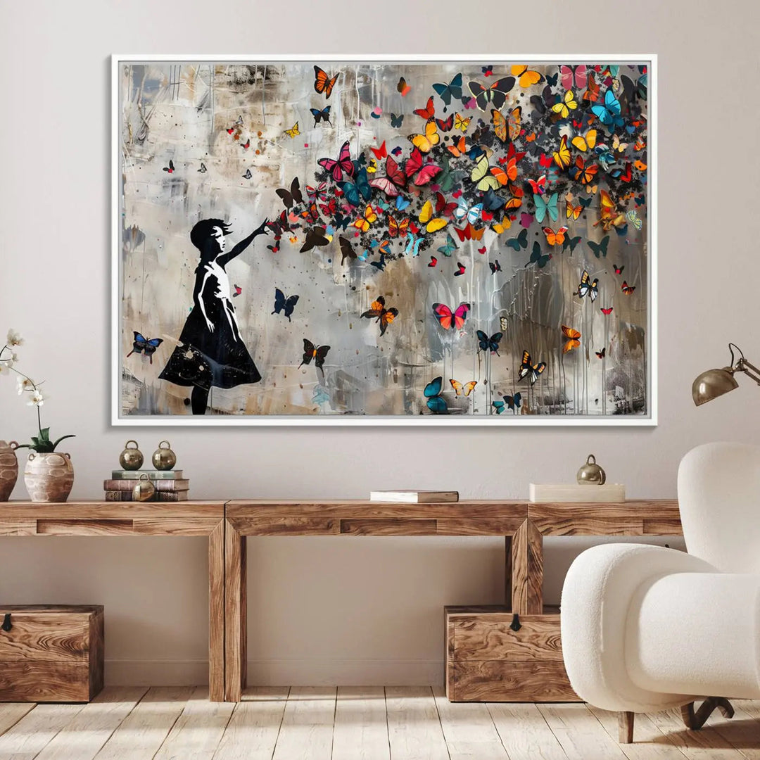 A person holding the Banksy Butterfly Girl Graffiti Canvas Wall Art.