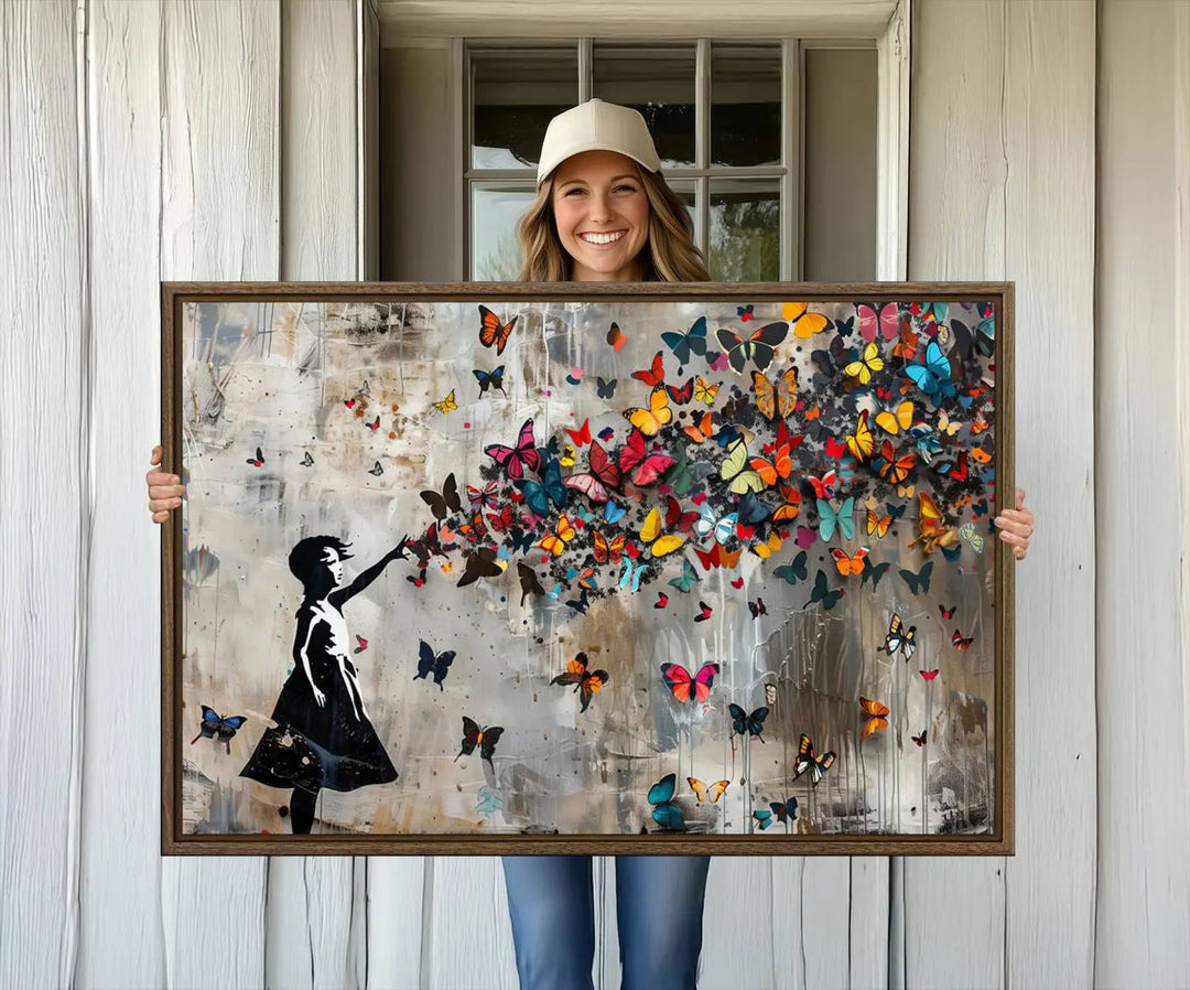 A person holding the Banksy Butterfly Girl Graffiti Canvas Wall Art.