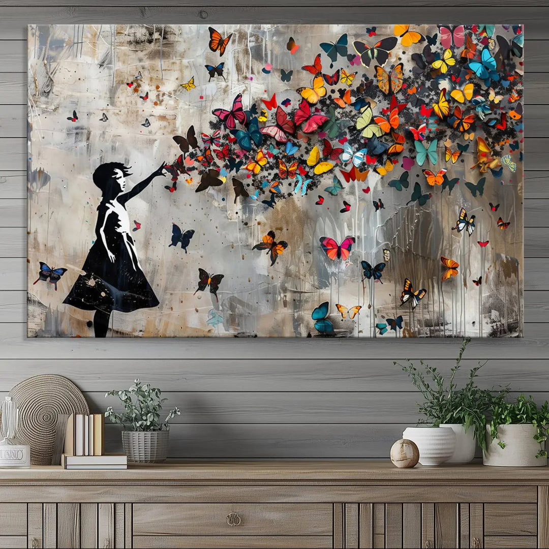 The Banksy Butterfly Girl 3-piece canvas art showcases a silhouette of a girl surrounded by colorful butterflies, perfect for modern living room decor.