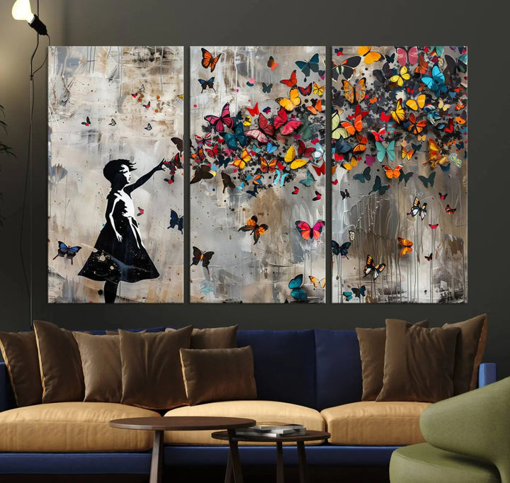 The Banksy Butterfly Girl 3-piece canvas art showcases a silhouette of a girl surrounded by colorful butterflies, perfect for modern living room decor.