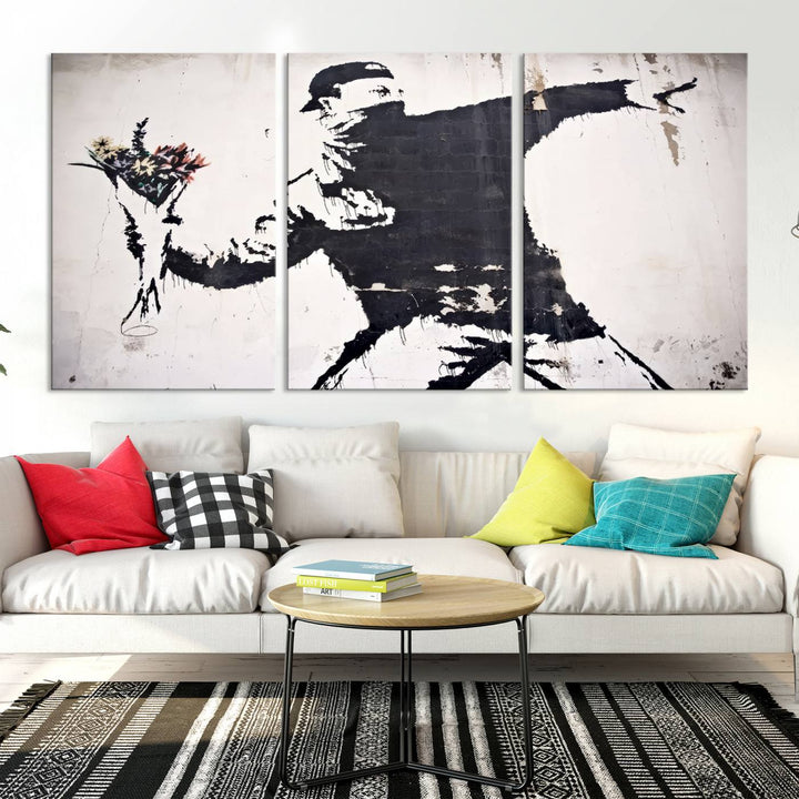 The living room features a split-panel art piece named "Banksy Flower Throw Graffiti Street Wall Art Canvas Print," gallery wrapped on museum-quality polycotton canvas and accentuated by modern decor elements.