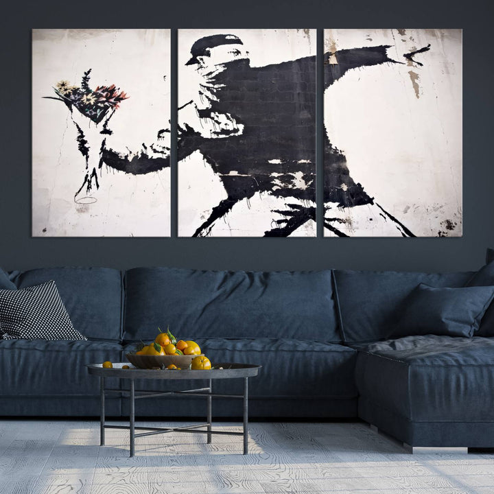 The living room features a split-panel art piece named "Banksy Flower Throw Graffiti Street Wall Art Canvas Print," gallery wrapped on museum-quality polycotton canvas and accentuated by modern decor elements.