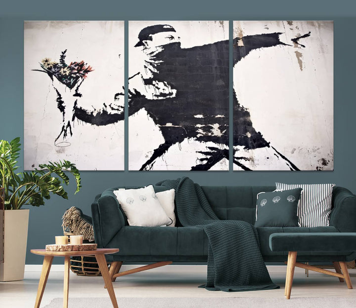 The living room features a split-panel art piece named "Banksy Flower Throw Graffiti Street Wall Art Canvas Print," gallery wrapped on museum-quality polycotton canvas and accentuated by modern decor elements.