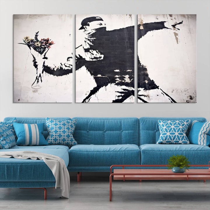 The living room features a split-panel art piece named "Banksy Flower Throw Graffiti Street Wall Art Canvas Print," gallery wrapped on museum-quality polycotton canvas and accentuated by modern decor elements.