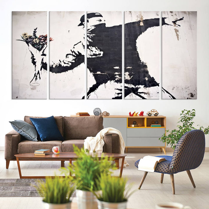 The living room features a split-panel art piece named "Banksy Flower Throw Graffiti Street Wall Art Canvas Print," gallery wrapped on museum-quality polycotton canvas and accentuated by modern decor elements.