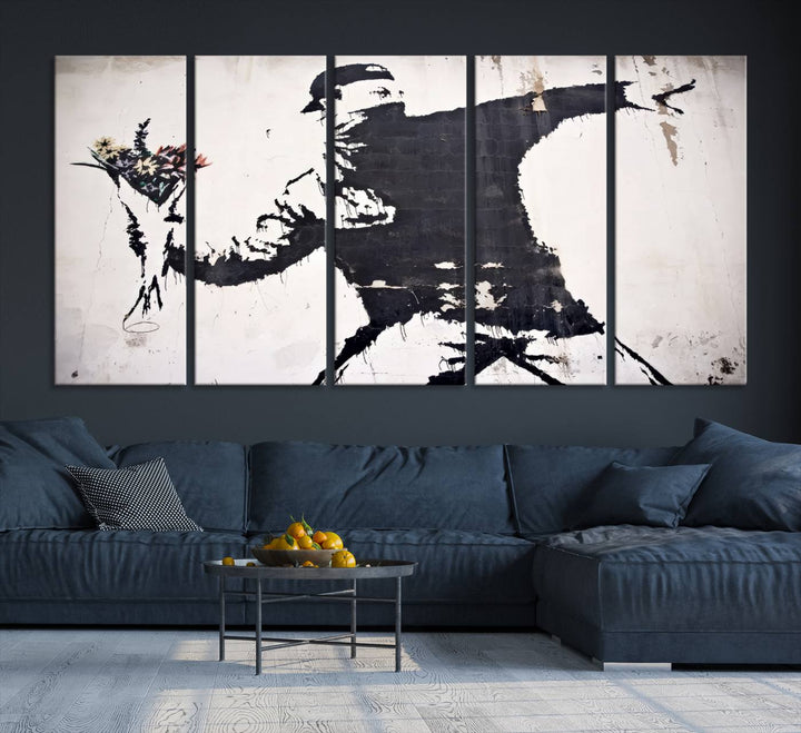 The living room features a split-panel art piece named "Banksy Flower Throw Graffiti Street Wall Art Canvas Print," gallery wrapped on museum-quality polycotton canvas and accentuated by modern decor elements.