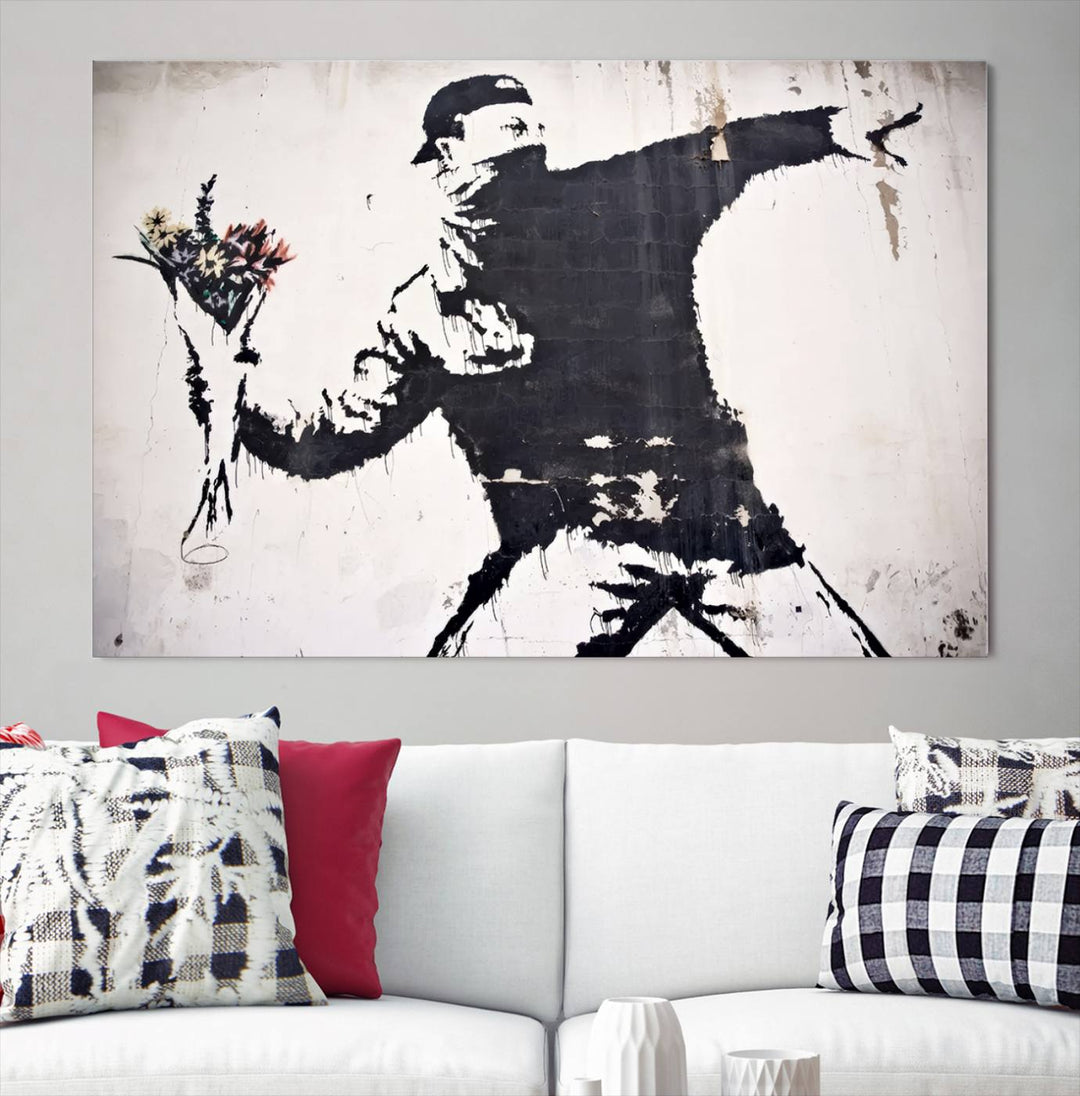 The living room features a split-panel art piece named "Banksy Flower Throw Graffiti Street Wall Art Canvas Print," gallery wrapped on museum-quality polycotton canvas and accentuated by modern decor elements.