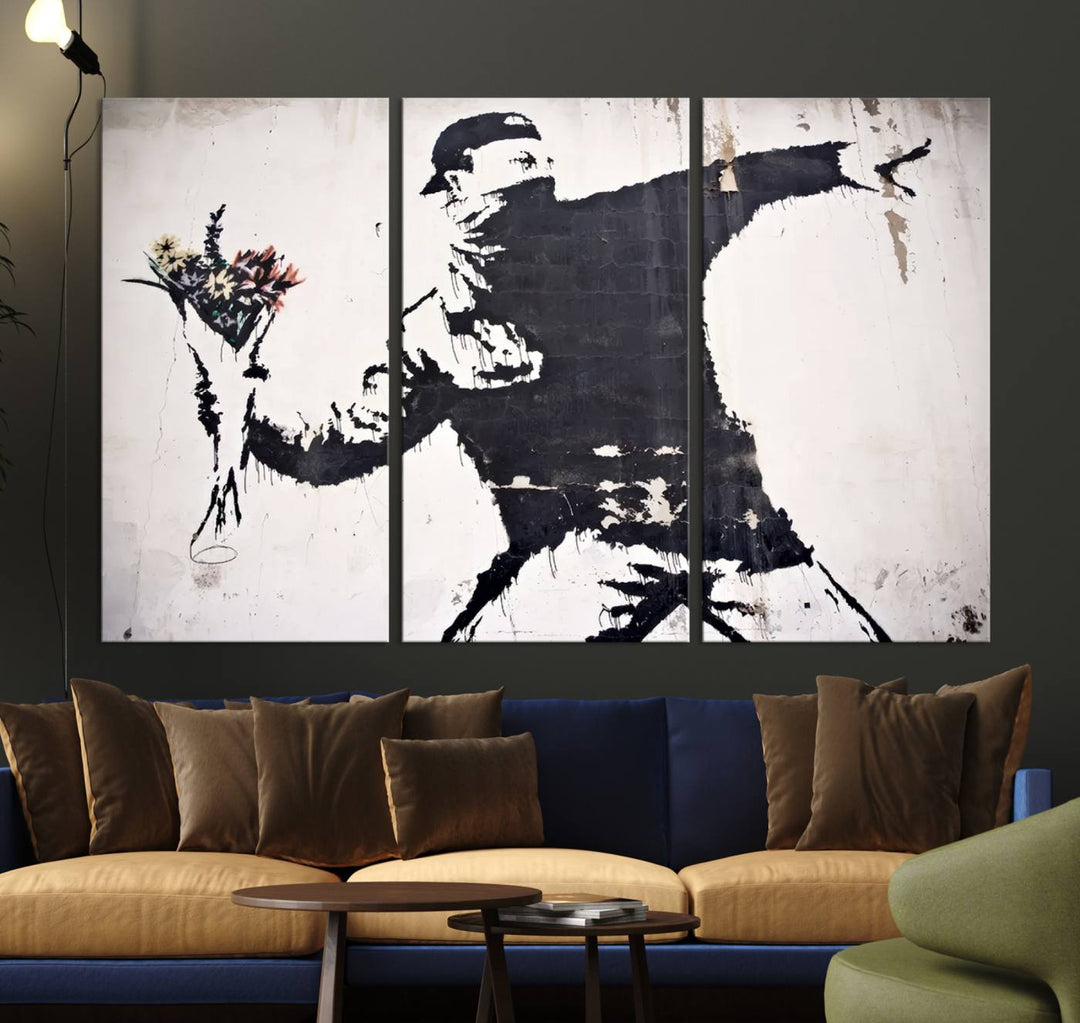 The living room features a split-panel art piece named "Banksy Flower Throw Graffiti Street Wall Art Canvas Print," gallery wrapped on museum-quality polycotton canvas and accentuated by modern decor elements.