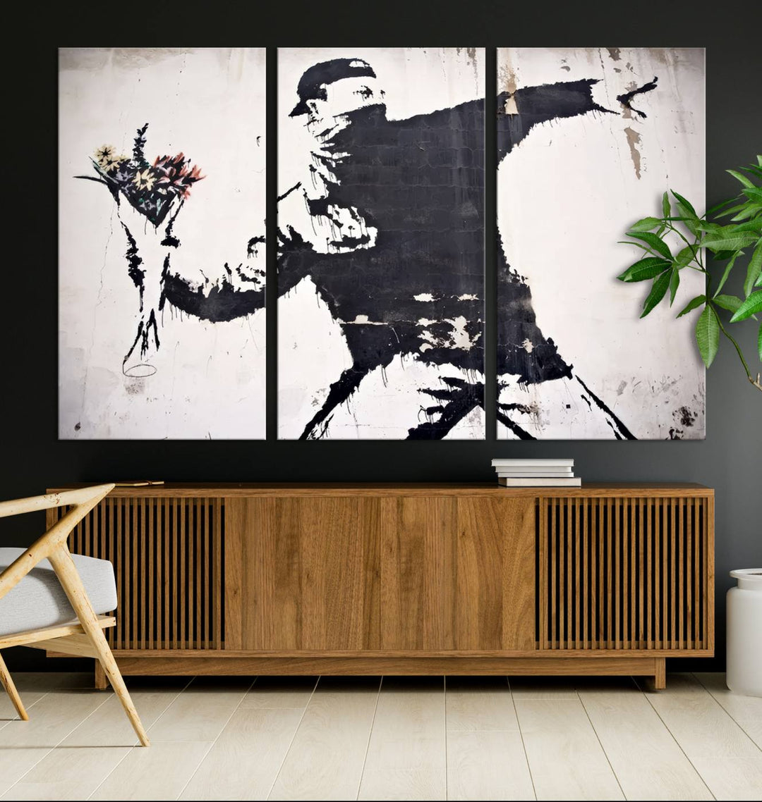 The living room features a split-panel art piece named "Banksy Flower Throw Graffiti Street Wall Art Canvas Print," gallery wrapped on museum-quality polycotton canvas and accentuated by modern decor elements.