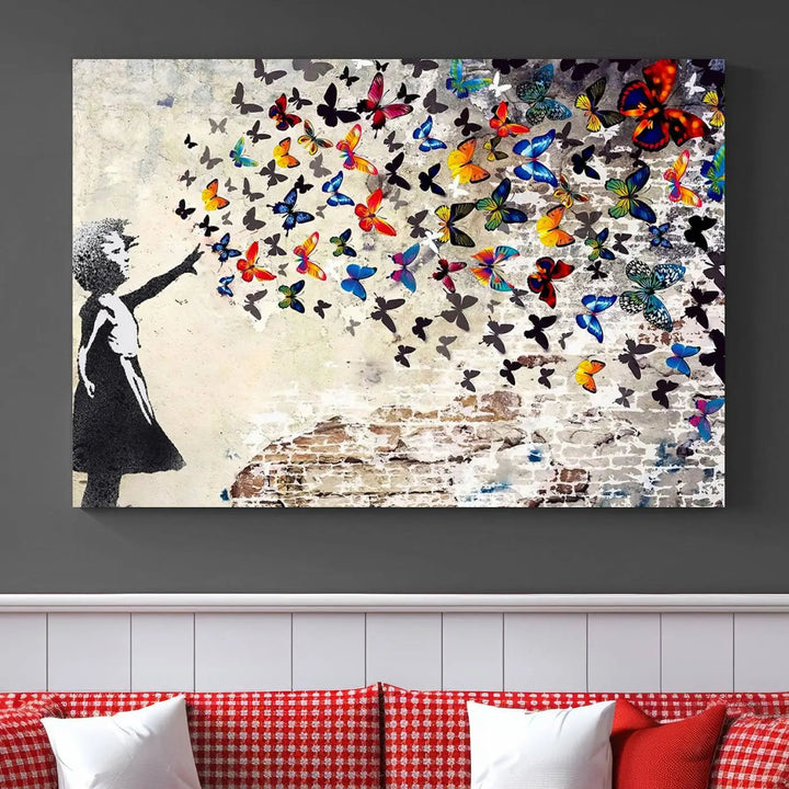 The Banksy Graffiti Wall Art Canvas Print, entitled 'Girl Releasing Vibrant Butterflies,' is a three-panel piece that is ready to hang.